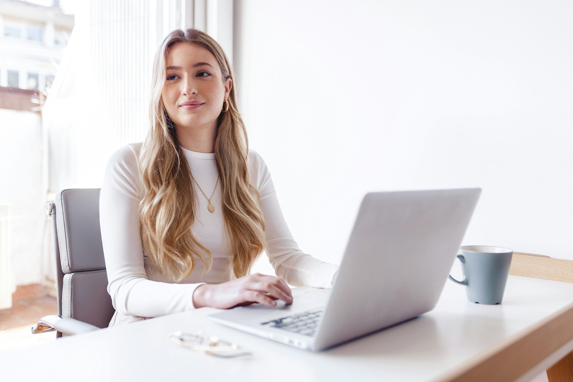 Blond woman working on her laptop at the office
